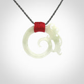 This is a hand carved Snow Jade dragon pendant. This is a medium sized necklace and is provided with an adjustable silver grey cord. Hand carved white jade dragon necklace for men and women.